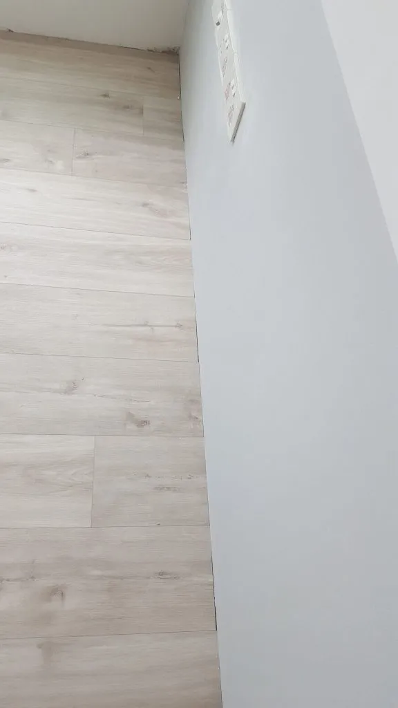There were some gaps between the end of the vinyl planks and the walls. That’s why we needed skirting to finish off the flooring, however much we hated it.