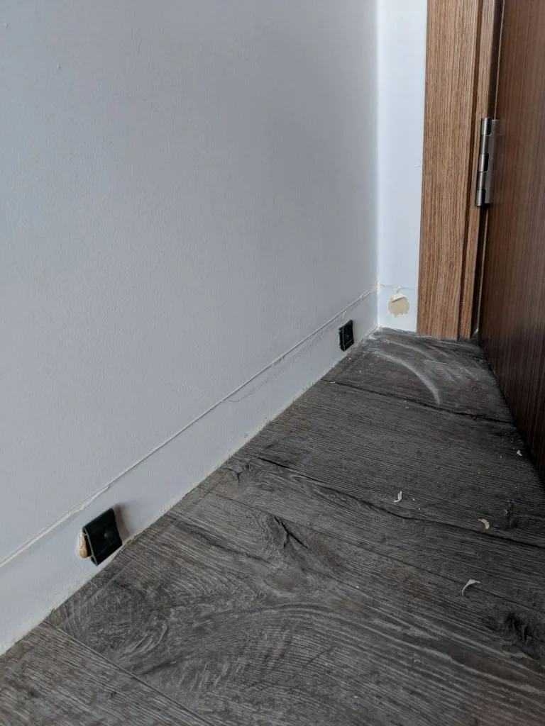 In case you're curious, glue and hooks hold onto the skirting. Be prepared for a lot of dust all around though!
