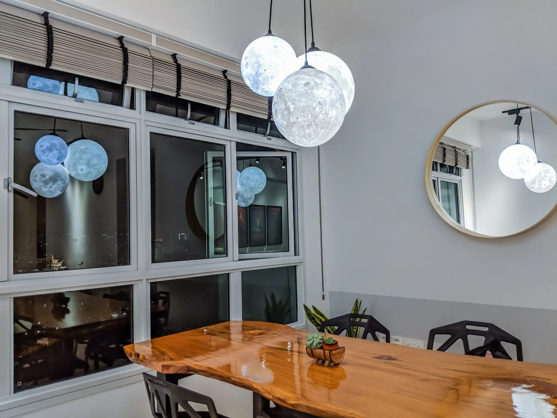 We bought these pendant lights shaped like moons because they fit our themes. They were very expensive but pretty. We really like the way they cast reflections on the windows and mirror, although those are typically obscured if we let down the blinds. Apologies if the table looks a little shiny, this photo was taken when we just applied a fresh layer of varnish to mend cracks on the table.