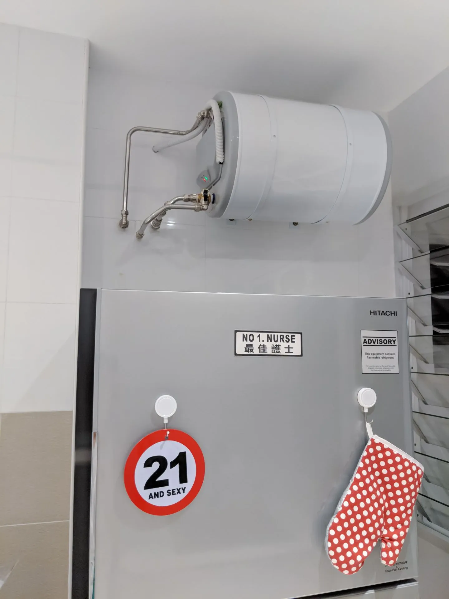 Our 395L fridge, which fits well and is sized just about right, under our electrical storage water heater. It's a 35L basic water heater that does its job well. The pipes can't be hidden unfortunately. The disadvantage of having the water heater above the fridge is that it would be disastrous if it leaks. Thankfully ours is a Joven water heater that comes with a 10-year non-leak guarantee, which should show the manufacturer's confidence in delivering good products that don't leak. Totally not an advertisement by the way haha.