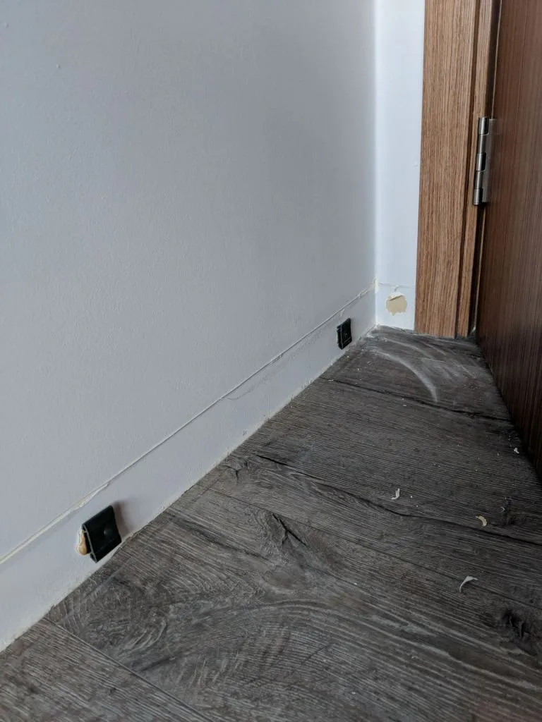 In case you’re curious, glue and hooks hold onto the skirting. Be prepared for a lot of dust all around though!