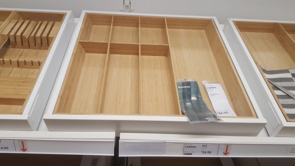 We chose to buy the bamboo utensils tray rather than the plastic one. It's much more expensive but the look fits much better.